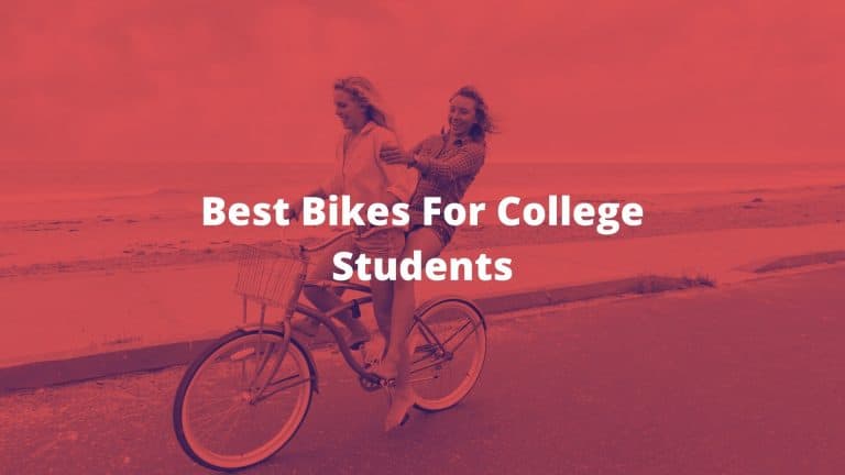 two college girls riding a bike right next to the beach
